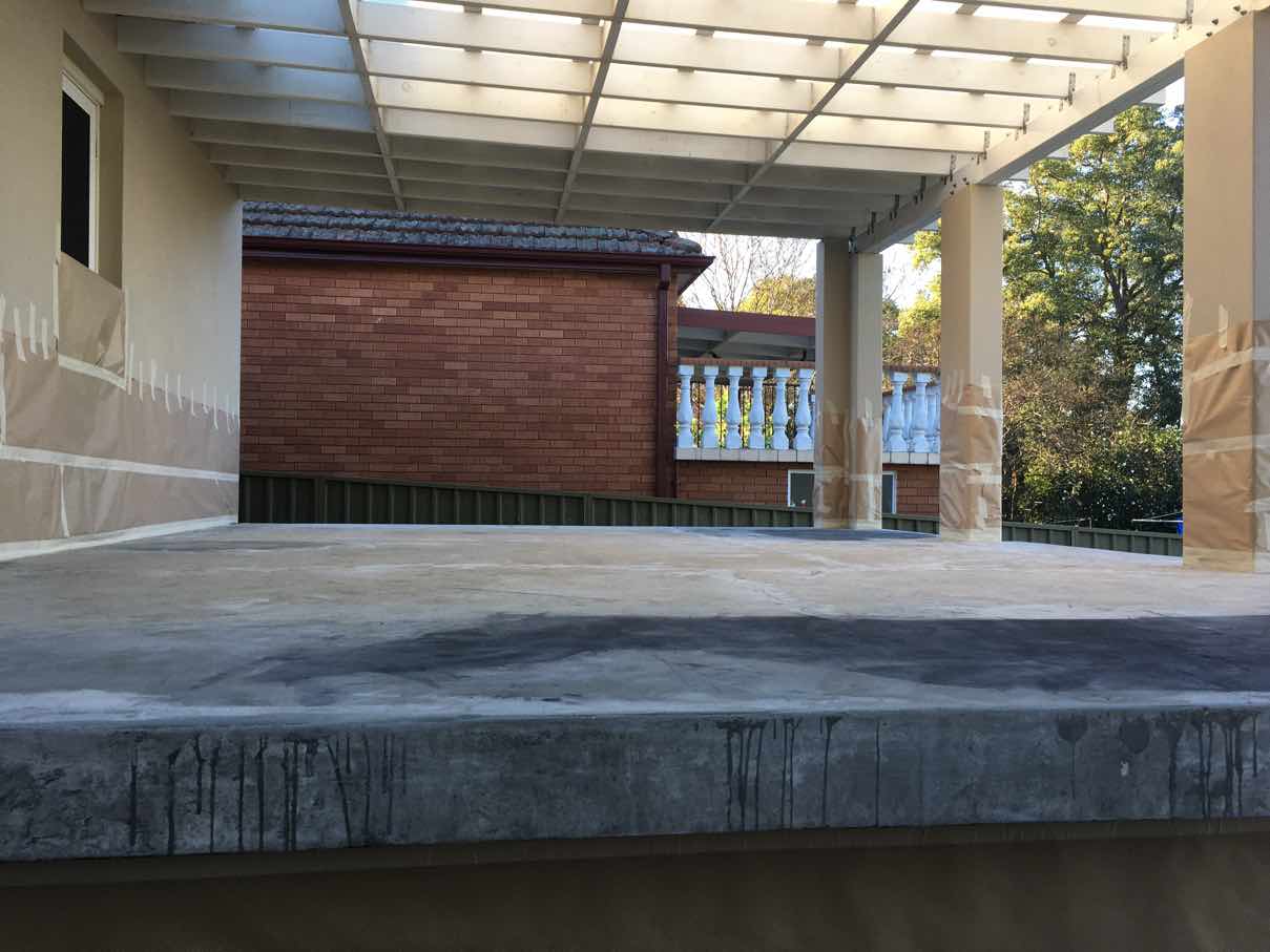 Primer and base coat applied to the edge of a Parramatta patio slab