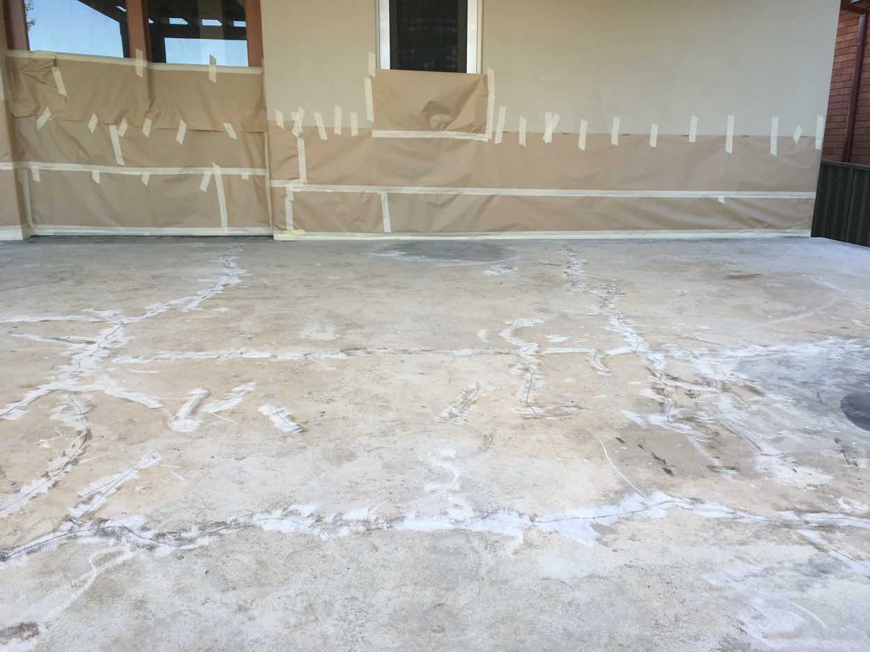 Parramatta patio concrete after pressure washing with cracks cut out and filled, walls masked