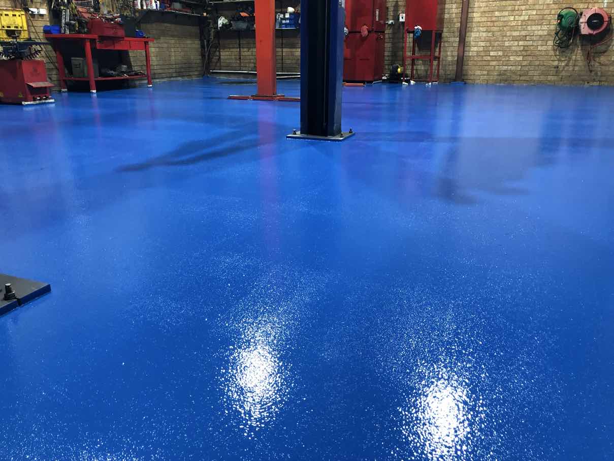 Real DaniCrete industrial workshop with a plain blue epoxy floor