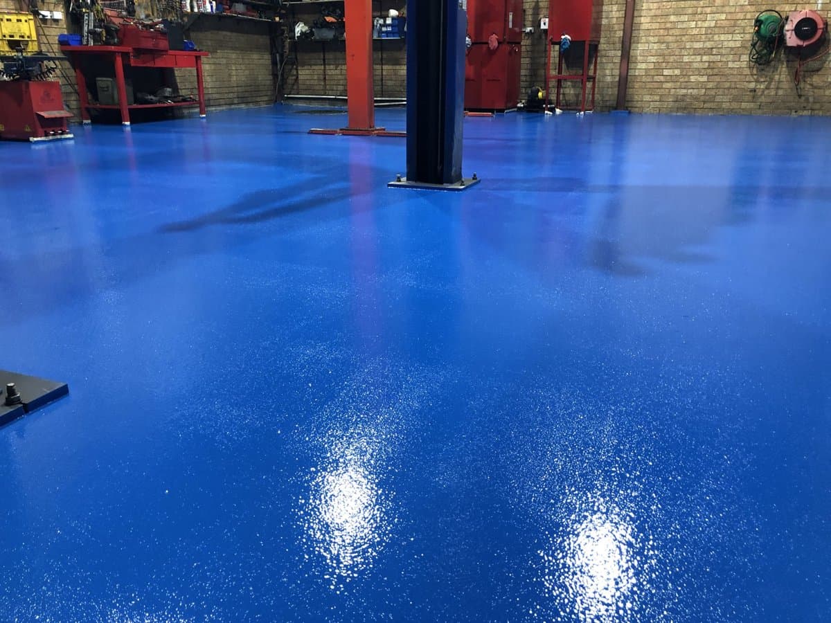 Real DaniCrete industrial workshop with a plain blue epoxy floor