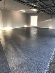 Residential garage finished with dark epoxy flake flooring by DaniCrete