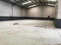 Warehouse concrete floor before DaniCrete epoxy flooring