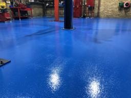 Workshop floor finished with blue plain epoxy by DaniCrete